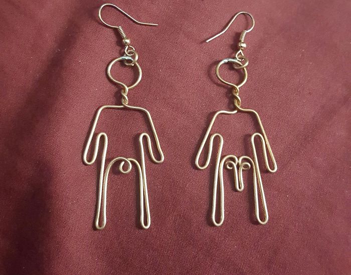 Wire earrings shaped into playful human figures, showcasing dad-level jokes.