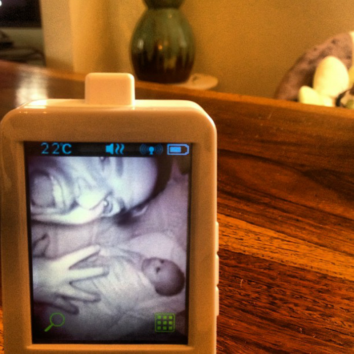 A dad photobombs baby monitor, showcasing humor in parenting.