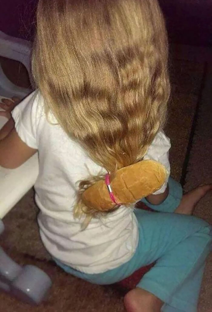 Dad joke: A girl's hair tied with a bread roll instead of a hair tie for a humorous effect.