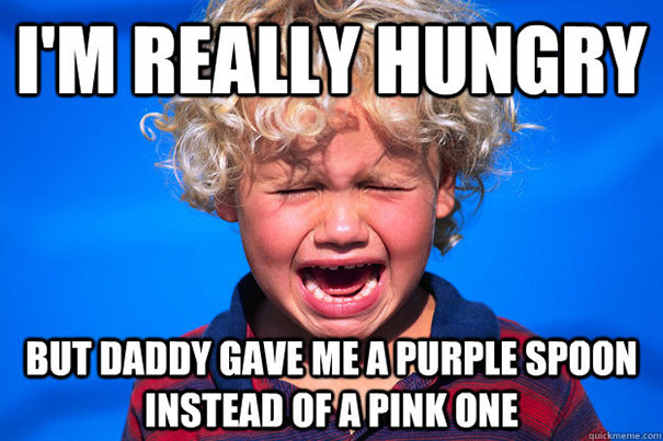 Child crying over spoon color mix-up, capturing relatable parenting humor.