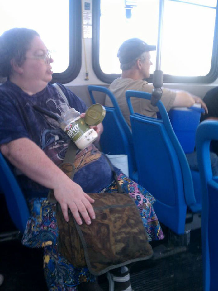 Person on a bus holding a jar of mayo, illustrating indifference.