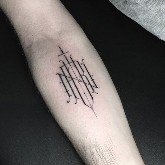 Delicate typographic tattoo on forearm, showcasing Léo Gavaggio's sophisticated design style.
