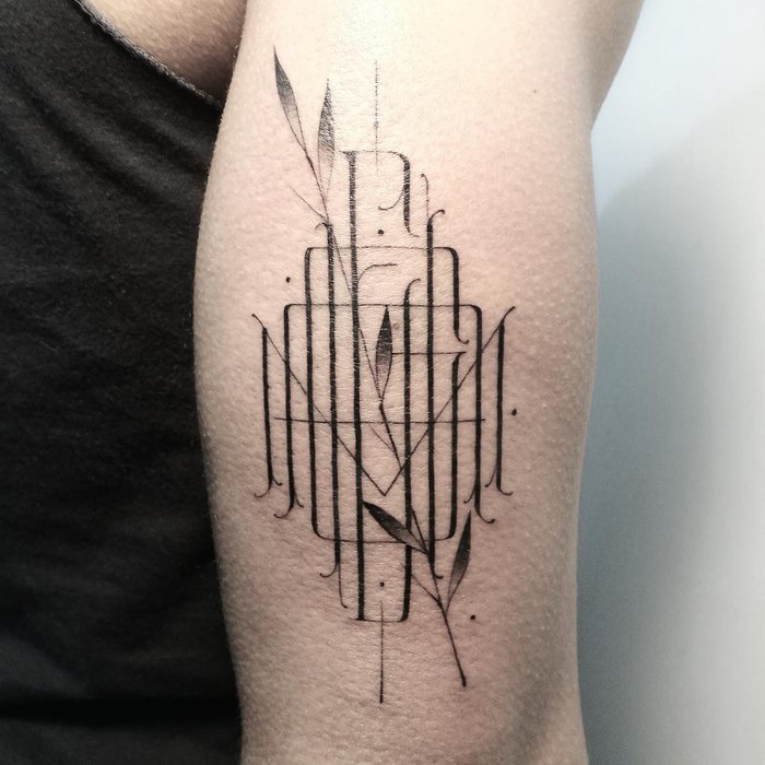 Delicate and sophisticated typographic tattoo design on arm by Léo Gavaggio.