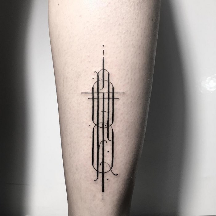 Delicate and sophisticated typographic tattoo design on inner forearm.