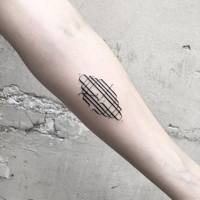 Delicate and sophisticated typographic tattoo on forearm.