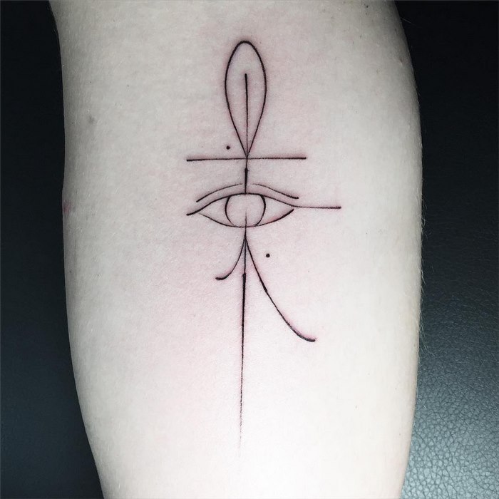 Delicate and sophisticated typographic tattoo by Léo Gavaggio, featuring abstract shapes and fine lines on skin.