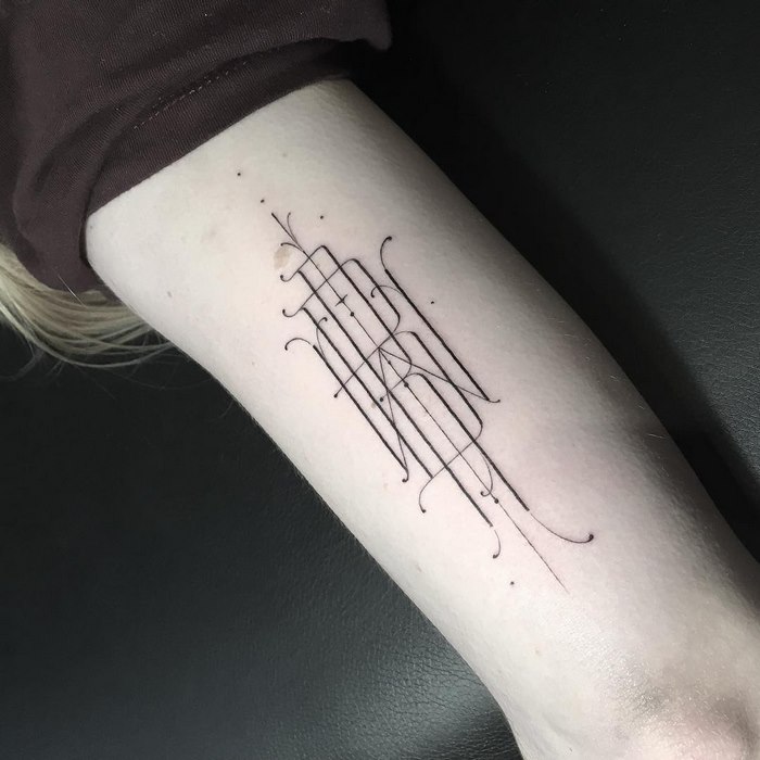 Delicate and sophisticated typographic tattoo on forearm by Léo Gavaggio.