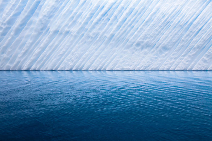 The Edge Of An Iceberg Floating Just Off The Coast Of Antarctica