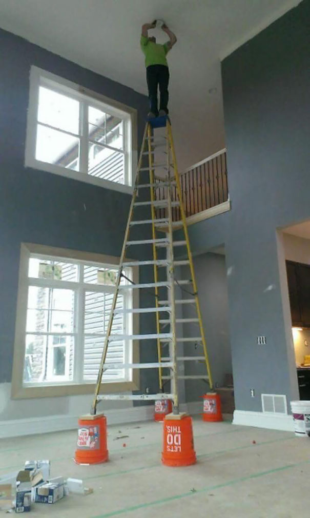 Man on a precarious ladder setup, highlighting risky behavior and safety concerns related to why women live longer than men.