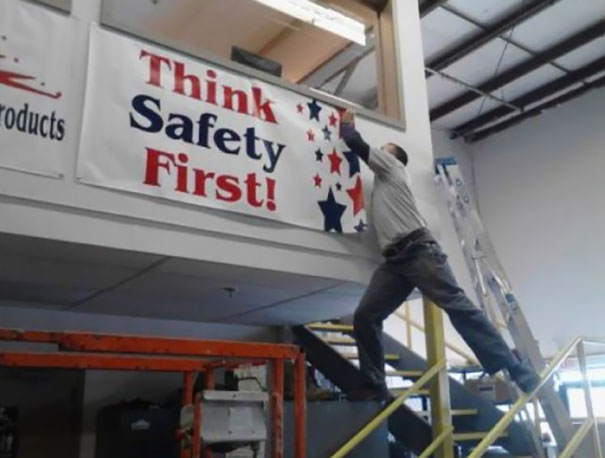 Man precariously reaching for stars on a "Think Safety First!" sign; demonstrates why women live longer than men. Man precariously reaching for stars on a "Think Safety First!" sign; demonstrates why women live longer than men.
