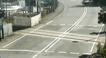 A driver narrowly escapes a train crossing, illustrating risks impacting why women live longer than men.
