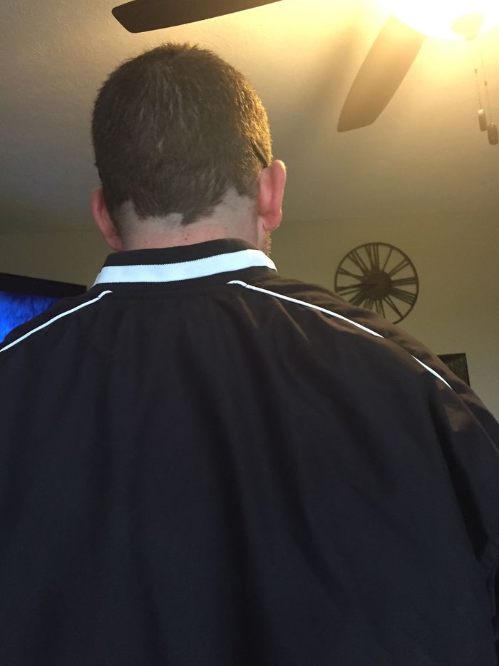 A man facing away in a room, highlighting dating an idiot theme with casual setting and wall clock decor.