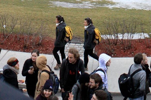 Two womans walking and wearing same clothes and bags