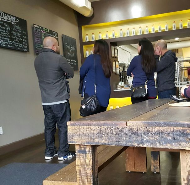 Two man and two womans standing looking and wearing same clothes