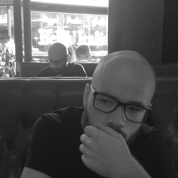 Two man sitting and looking similar