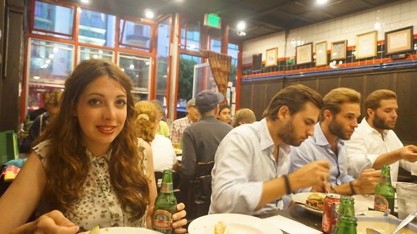 Three man sitting at the table and wearing same shirts and looking similar