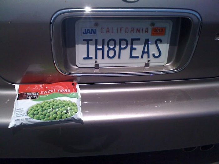 Car with "IH8PEAS" license plate and bag of sweet peas on the bumper, showcasing hilarious wives' humor.