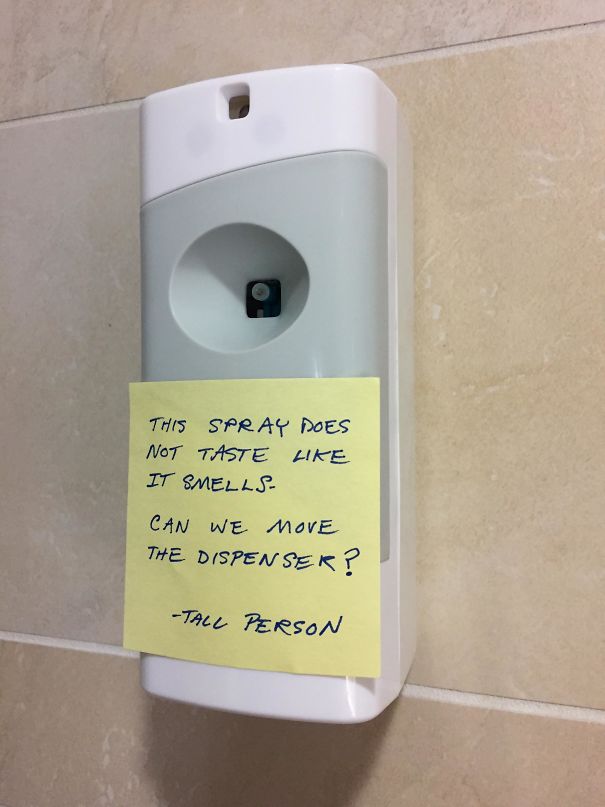 Air freshener dispenser with a note from a tall person about spray being at an inconvenient height for tall people.