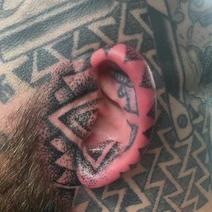 Close-up of a helix tattoo on an ear with geometric patterns, showcasing the latest Instagram tattoo trend.