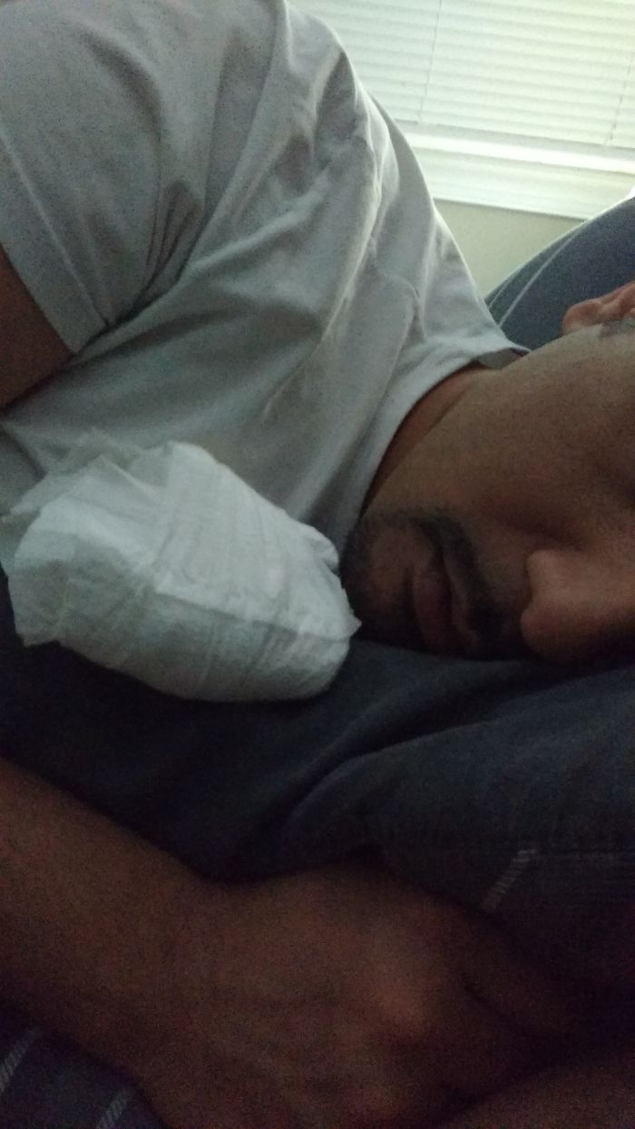 Man sleeping with a diaper taped to his shoulder as a prank by his hilarious wife.