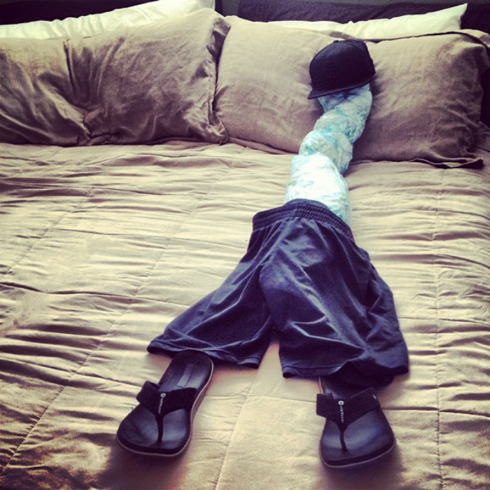 A wife creates a funny husband dummy on the bed with clothes and a cap, showcasing a hilarious prank.