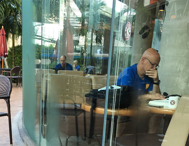 Two person sitting and wearing similar blue shirts