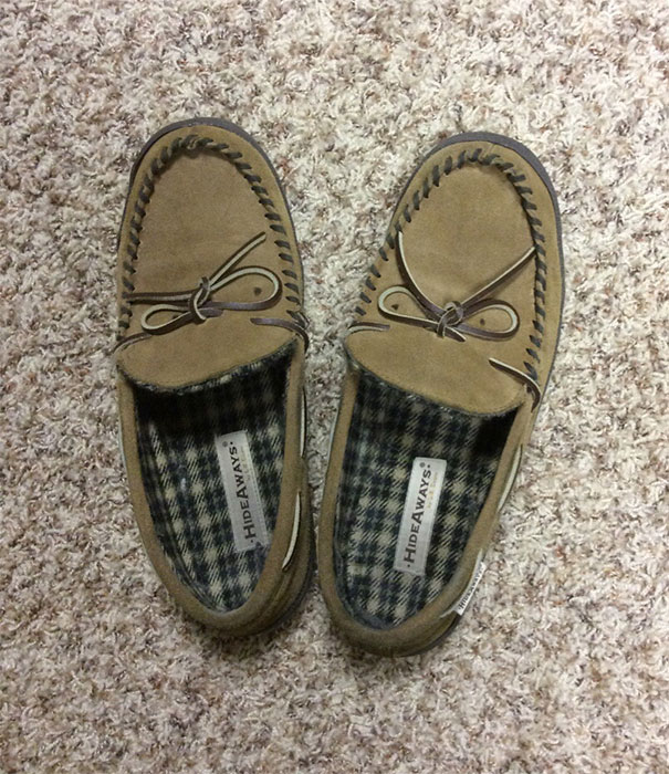 Pair of brown slippers on carpet, with pareidolia effect making them look like smiling faces in everyday objects.