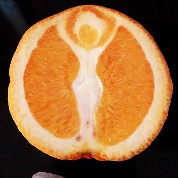 Orange slice showing pareidolia, resembling a human figure, as a funny example of pareidolia in everyday objects.