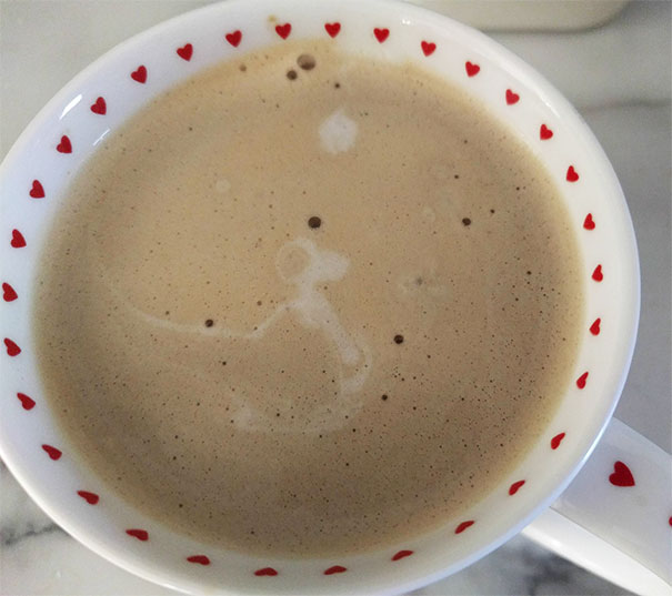 Cup of coffee with foam shaped like a kangaroo, a funny example of pareidolia in everyday objects.