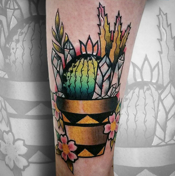Colorful succulent tattoo with a geometric pot and flowers, ideal for succulent enthusiasts.