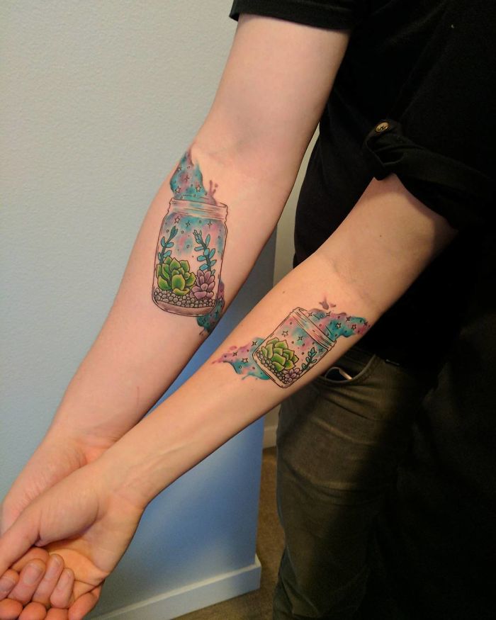 Colorful succulent tattoos in jars on forearms, perfect for succulent enthusiasts.