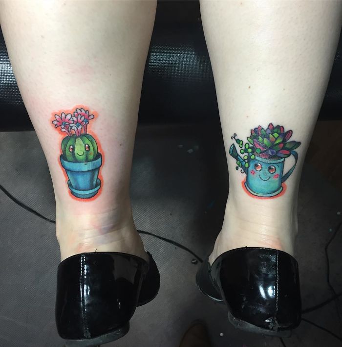 Colorful succulent tattoos on legs, featuring a cactus in a pot and succulents in a watering can.