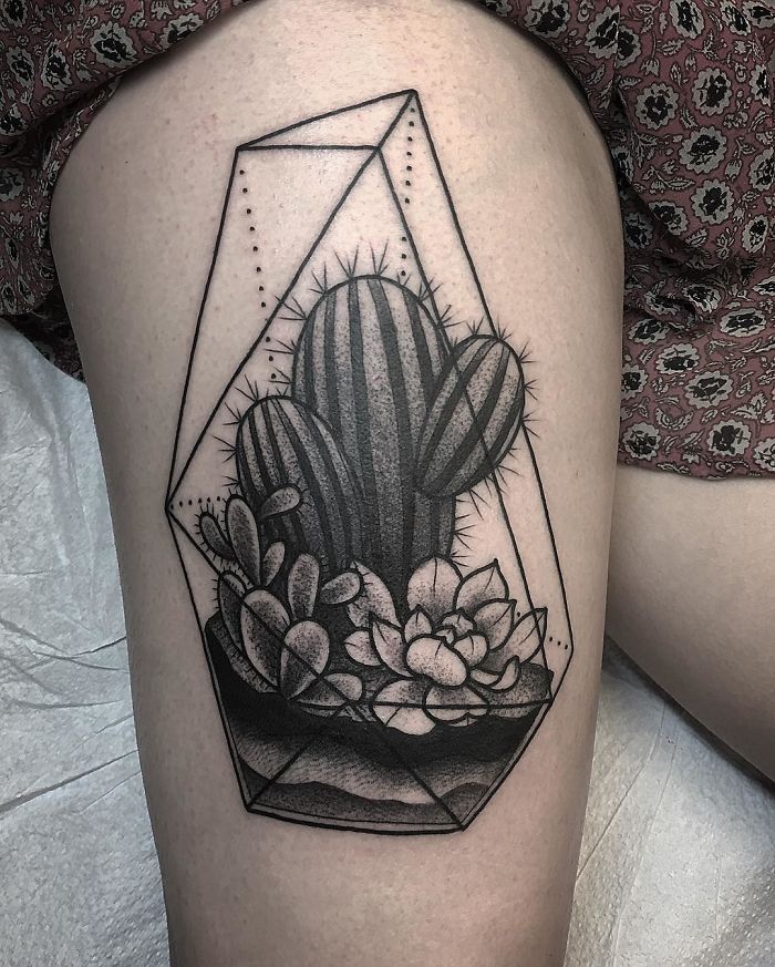 Succulent tattoo design featuring cacti and leaves in geometric style on a person's upper thigh.