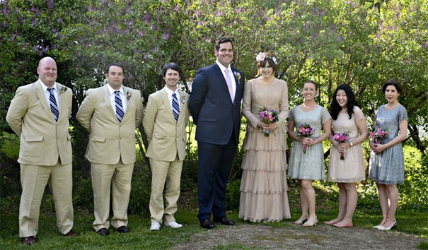 Tall people standing together at a wedding, highlighting height differences and everyday struggles in a formal outdoor setting.