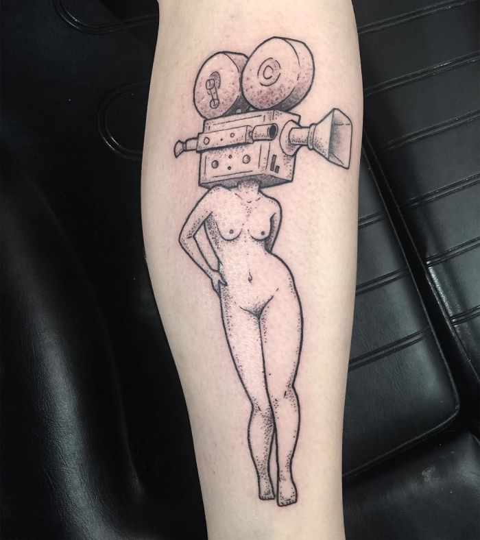 Tattoo of a headless girl with a vintage film camera as a head, designed by Molly Jean.