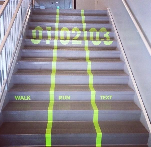 School stairs with lanes labeled walk, run, text in bright green markings, showcasing a clever school idea.
