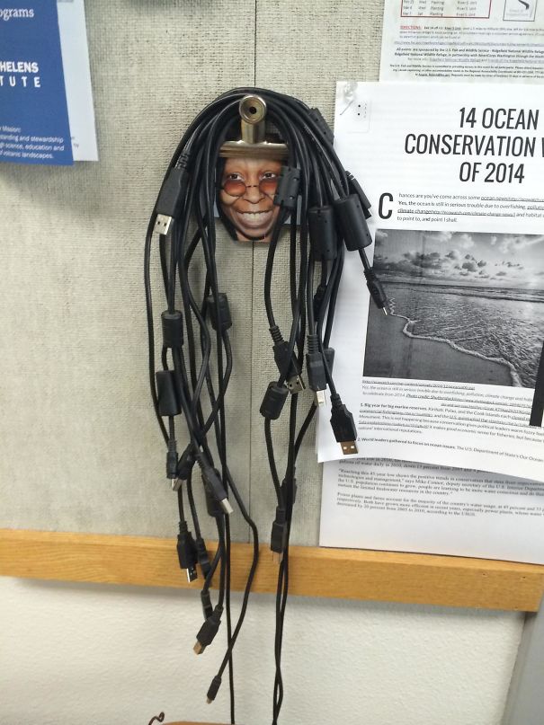 Creative school idea with cables forming hair on a humorous wall decoration with a face.