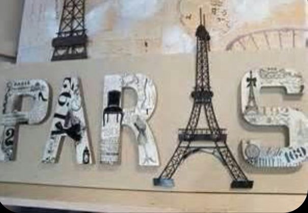 "Sign reading 'PARIS' with the Eiffel Tower replacing the letter A, showcasing design fails."