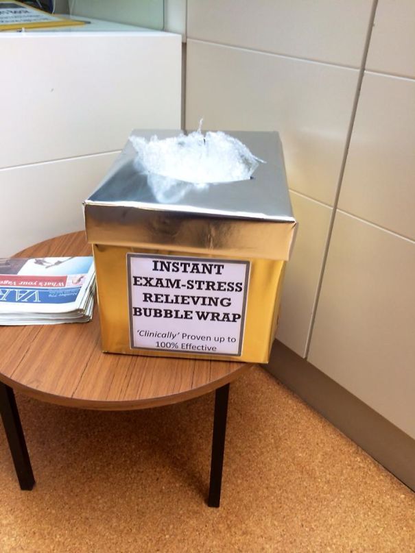 Box labeled "Instant Exam-Stress Relieving Bubble Wrap" on a table, designed for stress relief in schools.