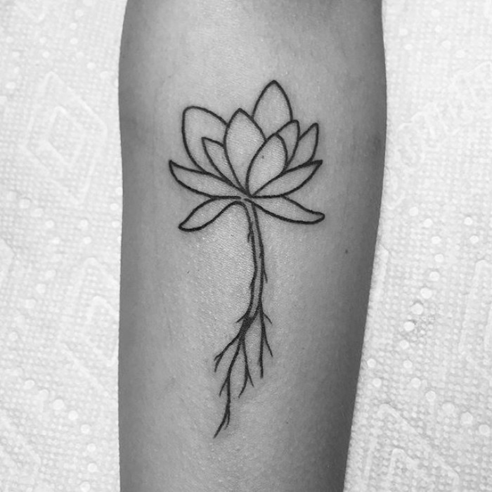 Succulent tattoo idea featuring a minimalist black ink design on an arm.