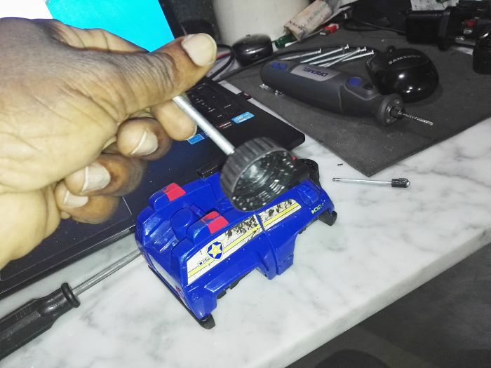 My Kid's Toy Car Lost Its Wheels Long Ago - So I Used Soda Bottle Tops To Fix These... See The Joy On His Face At The Result?