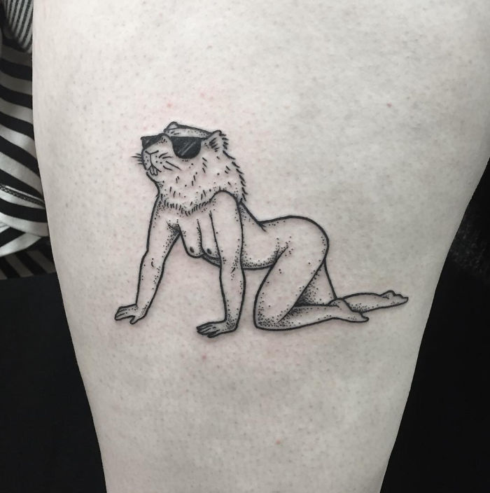 Tattoo of a headless girl with a lion's head wearing sunglasses, by Molly Jean.