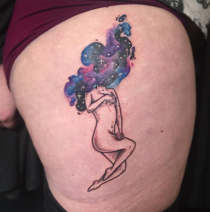 Tattoo of a headless girl by Molly Jean, featuring a cosmic theme on skin.