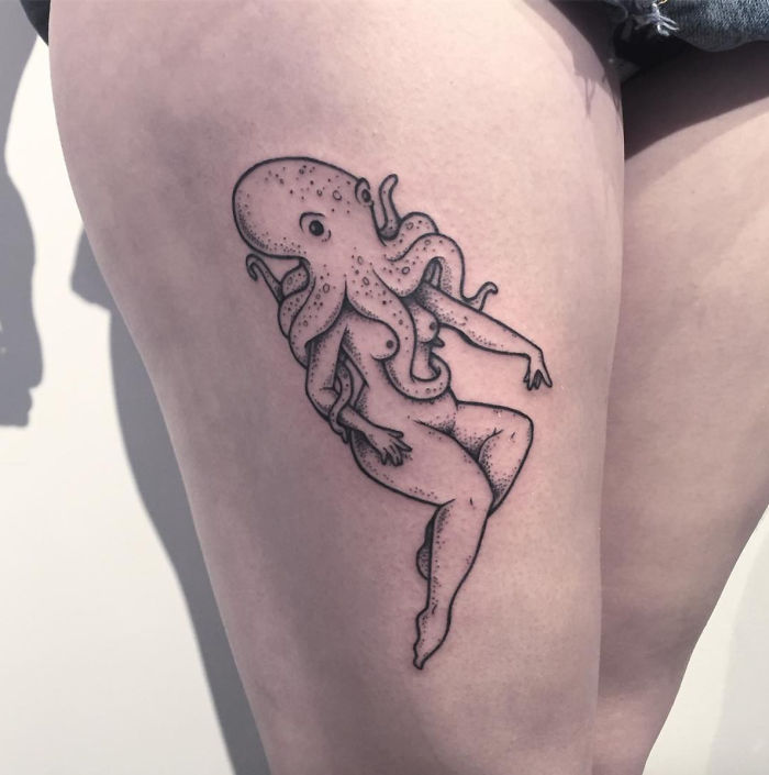 Tattoo of a headless girl with an octopus-like head on a person's thigh, showcasing unique artistry.