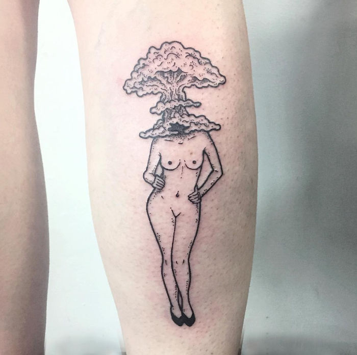 Tattoo of a headless girl with a mushroom cloud for a head by Molly Jean.