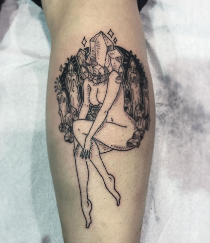 Tattoo of a headless girl with crystal details on a leg by Molly Jean.