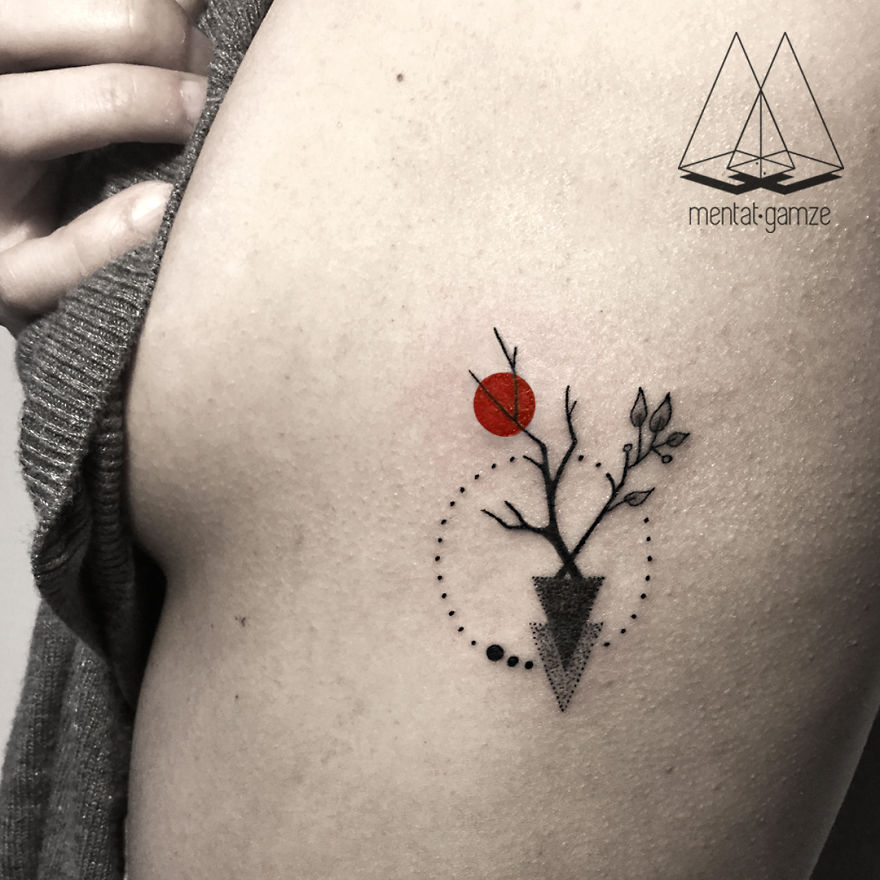 Abstract tattoo with geometric shapes and a red dot on skin, representing a transition to a tattoo artist career.