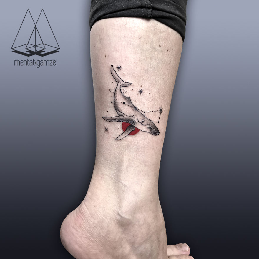 Whale tattoo with red dot and stars on leg, illustrating a creative tattoo artist's work.