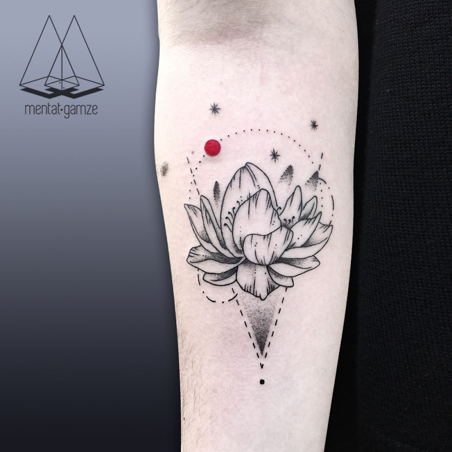 Black and gray lotus tattoo with a red dot on forearm, featuring delicate dot work and geometric lines.