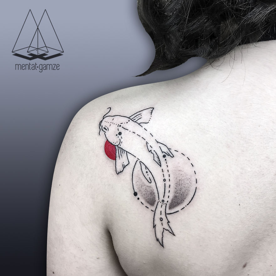 Tattoo artist designs a koi fish with a red dot on shoulder, showcasing unique style and creativity.